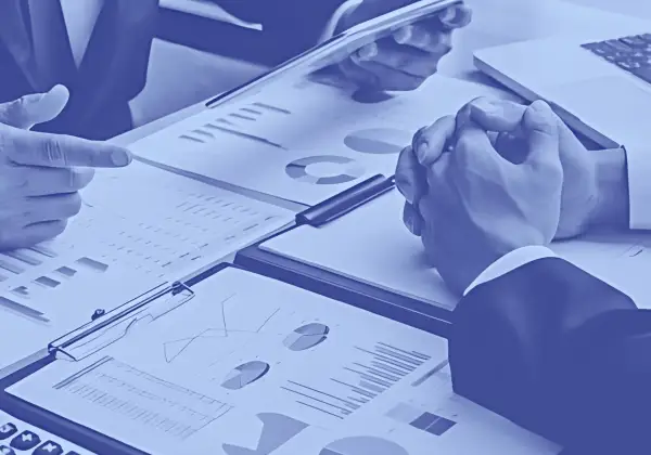 blue and golden graphic image with men and women in suits sitting around atbale